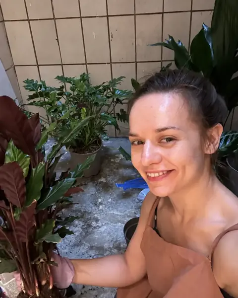 Daria working hands-on with an indoor plant